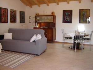a living room with a couch and a table at A 7 KM DA SALO' CASA DEL SOLE MANSARDA in Gavardo