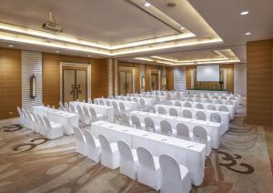 a conference room with white chairs and a screen at Sukhothai Heritage Resort in Sawankhalok +34 photos