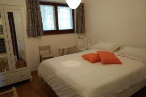 1 dormitorio con 1 cama con 2 almohadas rojas en Vista Lago Due, en Stresa