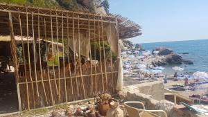a group of people on a beach near the ocean at Apartmani Rakocevic in Sutomore