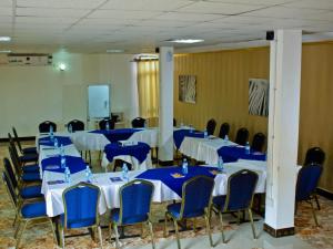 a room with blue and white tables and chairs at Al-Nisaa Hotel and Spa in Jinja