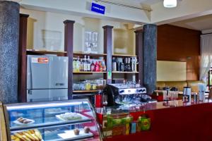 a kitchen with a refrigerator and a counter with food at Al-Nisaa Hotel and Spa in Jinja