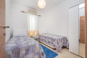 Postel nebo postele na pokoji v ubytování Apartments Elica