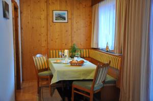 a dining room with a table and chairs and a window at Alpenspirit in Sölden