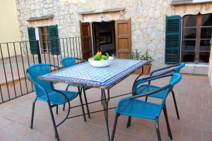 a table with chairs and a bowl of fruit on a patio at Cas Canonge, cosy and comfortable place in Artà in Artá