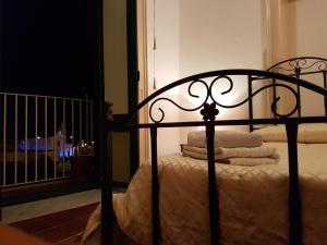 a black bed with white sheets and pillows on it at B&B Ventura in Lipari
