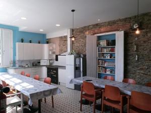 a kitchen with a table and chairs in a room at Albergue Savior in Lourenzá