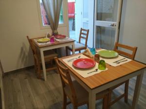 a dining room with two tables and two chairs at Perla del Sud - Guest House in Lampedusa