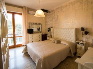 a bedroom with a bed and a large window at Hotel Atlantico in Castiglioncello