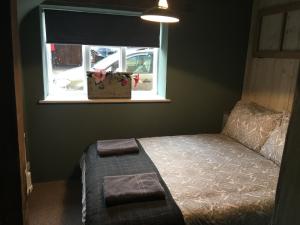 a bedroom with a bed and a window at Square House Bildeston High street in Ipswich