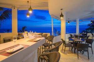 a restaurant with a view of the ocean at night at whala!bayahibe - All Inclusive in Bayahibe
