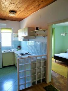 a kitchen with white cabinets and a counter top at Apartments Lukacic in Tkon