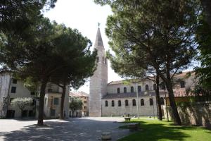 an old building with a tower and a church at Residence Mirage in Grado