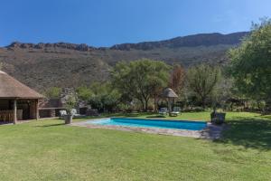 a yard with a swimming pool and a gazebo at Lemoenfontein in Beaufort West