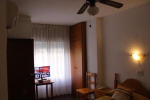 a living room with a couch and a window at Pension Americano in Almería