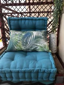 a blue tufted bed with a pillow on a porch at Casa Anastasia I in Buendía