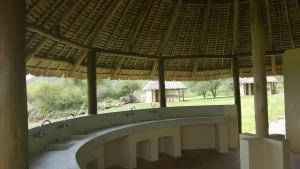 a view of a building with a large roof at Migombani Camp in Mto wa Mbu