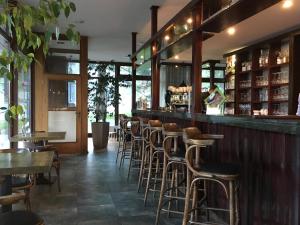 a bar with a row of stools in a restaurant at Apartmán Crocus 313 in Štrbské Pleso