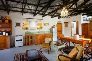 a kitchen with a table and a dining room at The Farmers Cottage Bethulie in Bethulie