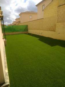a green artificial lawn in a building at Vivienda Rural in Olivares
