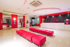 a waiting room with red benches in a store at Red Planet Cagayan De Oro in Cagayan de Oro