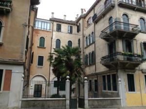 a building with a palm tree in front of it at Appartamento Sant'Elena in Venice
