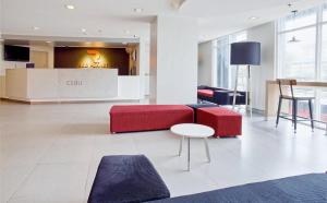 a living room with a red couch and a table at Red Planet Cebu in Cebu City