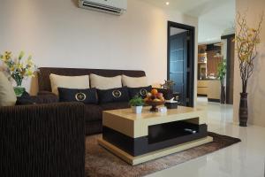 a living room with a couch and a coffee table at Nagoya Mansion Hotel and Residence in Nagoya