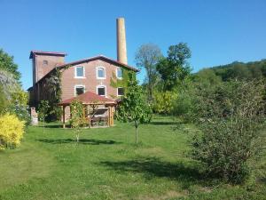 an old brick house with a chimney on a field at Villa Oranje in Bolków