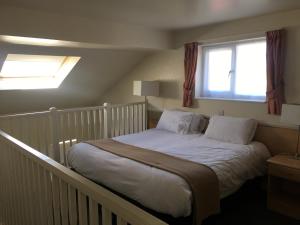 A bed or beds in a room at Moreton Park Hotel 
