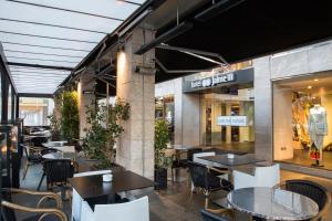 a restaurant with tables and chairs in a building at HM Jaime III in Palma de Mallorca