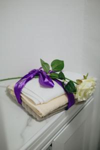 a stack of towels with a purple bow on a shelf at Old Town Apartment Split in Split