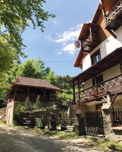 ein Haus mit einem Tor neben einem Gebäude in der Unterkunft Vatra Hotel in Jaremtsche