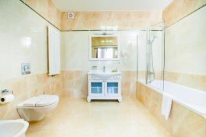 a bathroom with a toilet sink and a shower at Mackintosh Hotel in Kyiv