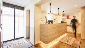 a kitchen with a counter and a man walking in a room at Hotel Imperial in Munich