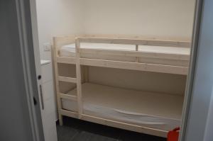a small room with a bunk bed in a room at Casa delle mimose in Varazze
