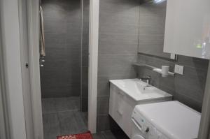 a bathroom with a white sink and a shower at Casa delle mimose in Varazze +24 photos