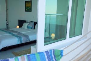 a bedroom with a bed and a large window at Silver Beach Delux Apartment in Byala +60 photos