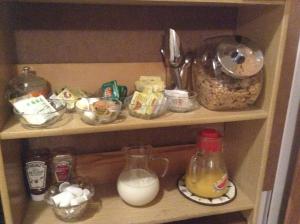 a cupboard filled with lots of food and milk at B&B Manoir Mon Calme in Quebec City