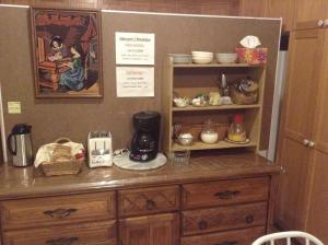 a wooden cabinet with a coffee maker on top of it at B&B Manoir Mon Calme in Quebec City