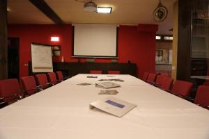 a conference room with a large white table and chairs at Estrella rural casa rural en la Sierra de Madrid in Buitrago del Lozoya