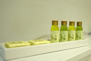three bottles of olive oil and cheese on a shelf at Belvedere Luxury Rooms - Breathtaking View in Split