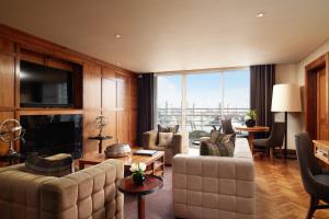 a living room filled with furniture and a large window at The Chelsea Harbour Hotel and Spa in London