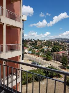 a view of a city from a balcony of a building at Beausejour Hotel in Kigali