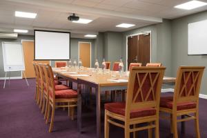 uma sala de conferências com uma mesa longa e cadeiras em Ramada Chorley South em Chorley