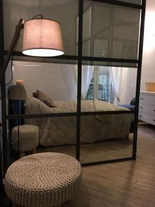 a bedroom with a bed and a lamp and a chair at Casa Margherita in Modica