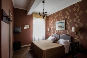 Postel nebo postele na pokoji v ubytování Hotel Residenza In Farnese