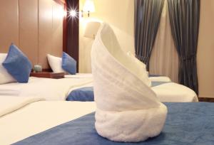 Postel nebo postele na pokoji v ubytování Burj Al Saif Hotel ـ فندق برج السيف