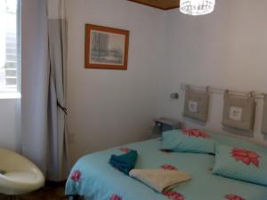 a bedroom with a bed with two pillows on it at L'Isle de Bourbon in Le Gué-de-Velluire