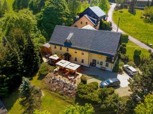an aerial view of a large house with a car at Hotel Sonne in Seiffen